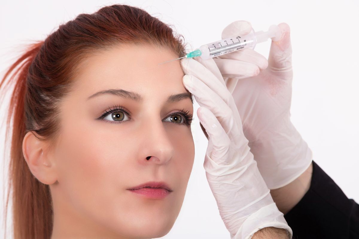 botox woman during facial correction treatment filling her wrinkles with hyaluronic acid.